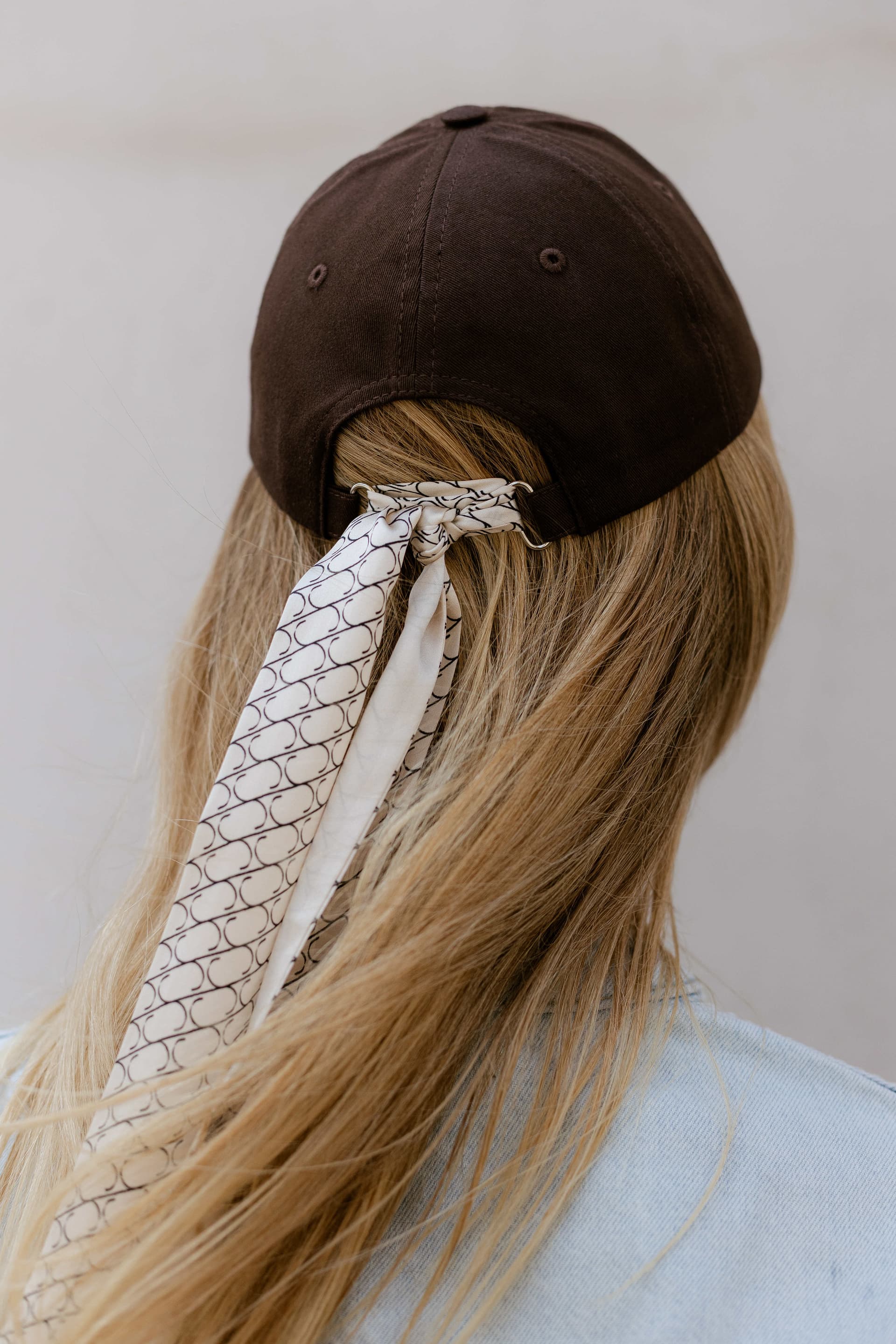 Brown baseball cap with optional silk accessory