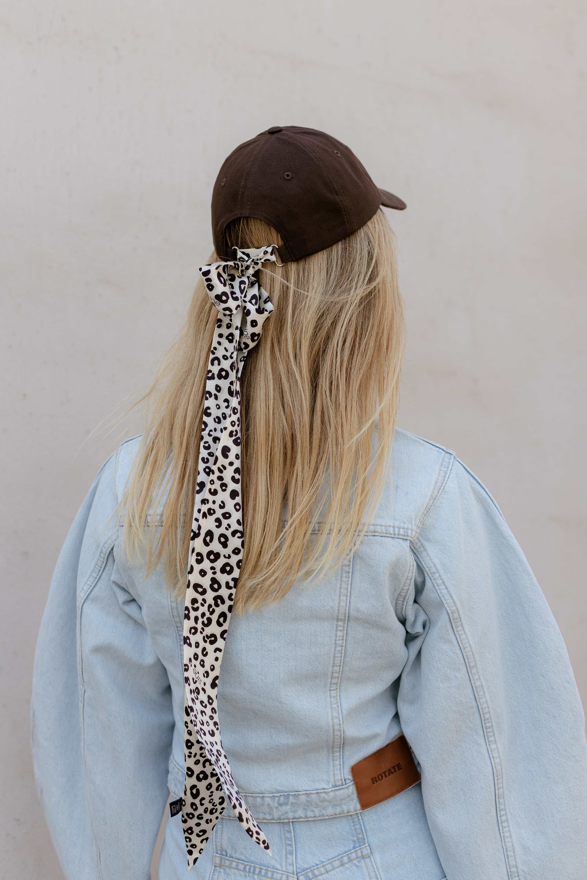 Brown baseball cap with optional silk accessory